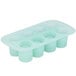 A light green silicone round dessert mold with 8 compartments.