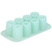 A light green Wilton silicone round dessert mold with 8 compartments.