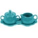 A turquoise Fiesta sugar and creamer tray set with bowls on a tray.