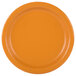 A close-up of an orange paper plate with a pumpkin spice orange background.