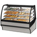 A True curved glass stainless steel dry bakery display case with trays of pastries.