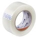 A roll of white Shurtape fiberglass reinforced strapping tape with a label on it.