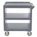 A granite gray plastic Cambro service cart with three shelves and wheels.