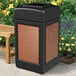 A black rectangular Commercial Zone StoneTec waste receptacle with brown Sedona panels.