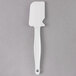A white Rubbermaid silicone spatula with a white handle.