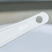 A close up of a white Rubbermaid high temperature silicone spatula with a white handle.