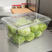 A clear plastic Cambro food storage container with lettuce inside.