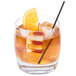 A Reserve by Libbey Symmetry old fashioned glass with ice and an orange slice.