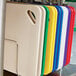 A Rubbermaid stainless steel rack holding a group of colored cutting boards.
