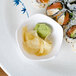 A Thunder Group Blue Bamboo plate with a bowl of sushi and ginger.