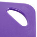 A purple plastic cutting board with a handle.