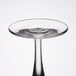 A close up of a clear Libbey wine glass with a round bottom and a clear rim.