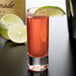 A Reserve by Libbey cordial glass filled with a pink drink and lime with a slice of lime on the rim.