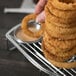 A Clipper Mill stainless steel tower holding fried onion rings with a ramekin holder.