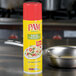 A yellow can of PAM Olive Oil Release Spray on a metal surface.