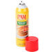 A red and yellow can of PAM Canola Release Spray on a table next to a stack of pancakes.