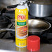 A silver PAM can of pancake cooking spray over a silver pan.