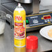 A yellow can of PAM Saute & Grill Release Spray on a counter.