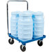 A white cart with three large blue Vollrath Traex ice totes.