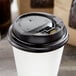 A white paper cup with a black Choice hinged lid.
