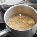 A pot of Organic Brown Short Grain Rice cooking on a stove.