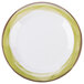 A close up of a GET Kanello white melamine plate with a wide rim and Kanello green edge.