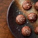 A plate of chocolate cookies with Regal salt crystals on top.