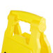 A yellow plastic Rubbermaid Double Sided Caution Wet Floor sign with a handle.