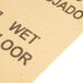 A yellow Rubbermaid absorbent pad with the words "wet floor" on it.