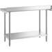 A silver stainless steel Regency work table with a shelf.