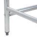 A stainless steel frame and legs for an Advance Tabco stainless steel work table.