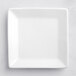An Acopa bright white square porcelain plate with a white rim.