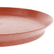 A close-up of a red round deli server tray with a short base.
