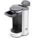 A silver and black Conair Cuisinart single cup coffee maker on a counter with the lid open.