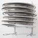 A wall mounted American Metalcraft pizza pan rack with 7 slots holding pizza pans.