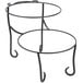 An American Metalcraft Ironworks two-tier round display stand with curled feet on a table in a bakery display.