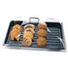 A Cambro clear dome display cover with 2 end cuts on a tray of pastries and muffins.