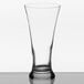 A close-up of a Libbey clear Pilsner glass with a black rim.
