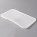 A white Carlisle rectangular plastic lid on a gray surface.