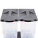 A pair of Carlisle plastic containers with black lids.
