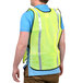 A man wearing a Cordova lime yellow high visibility safety vest.
