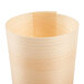 A close-up of a Tablecraft mini wooden serving cup with a curved surface.
