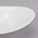 A white porcelain bowl with a curved rim.