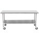 An Advance Tabco stainless steel work table with casters.