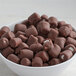 A bowl of milk chocolate mini marshmallow toppings.