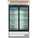 A white True refrigerated glass door merchandiser with LED lighting and three shelves.