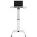 A white Luxor pneumatic adjustable height lectern with a laptop on it.