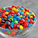 A bowl of M&M's on a table.