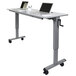 A Luxor adjustable height flip top nesting table with a laptop on it.