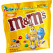 A yellow party size bag of Peanut M&M's with a blue and yellow cartoon character.